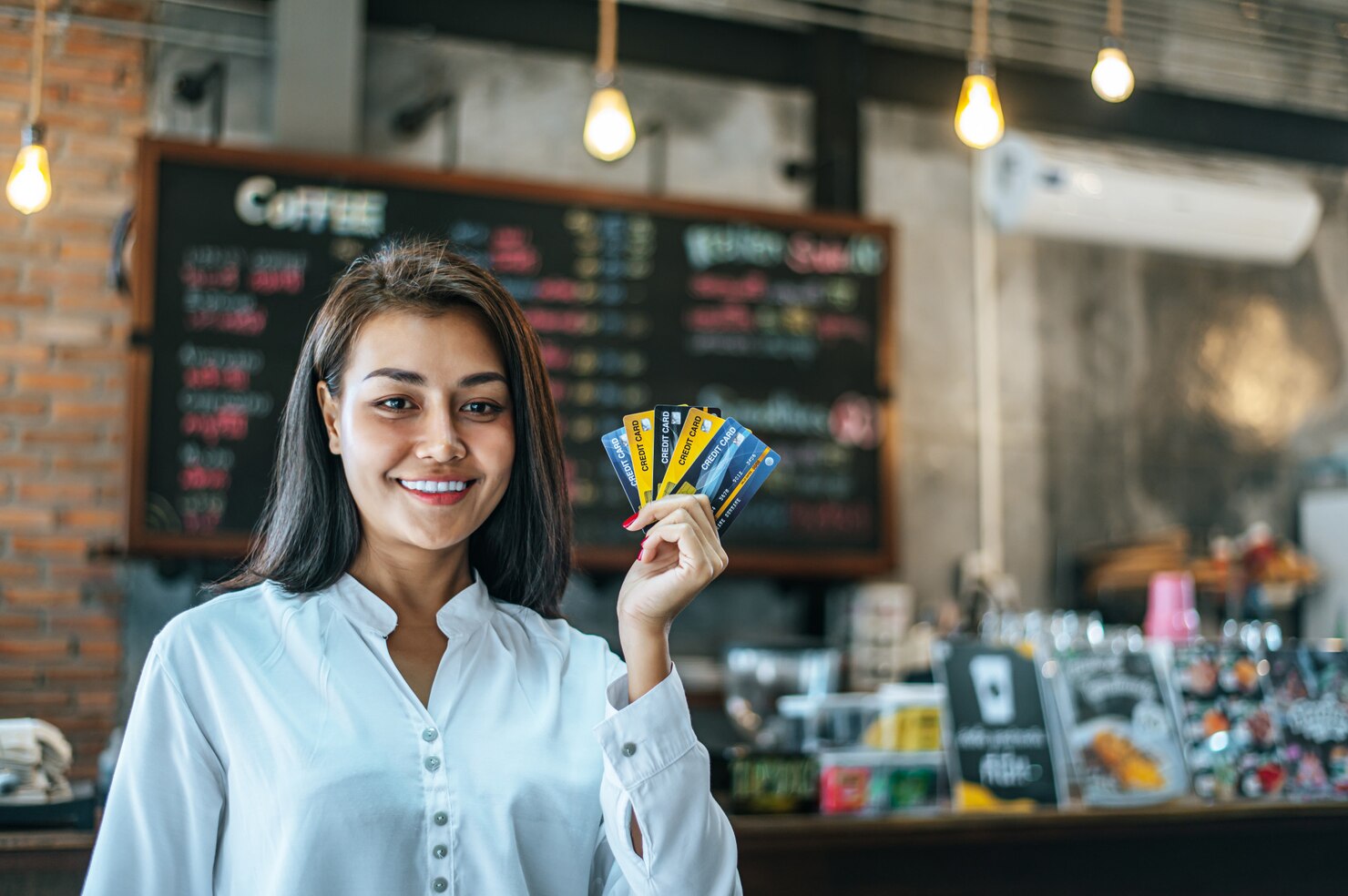 Young woman enjoying shopping with credit cards